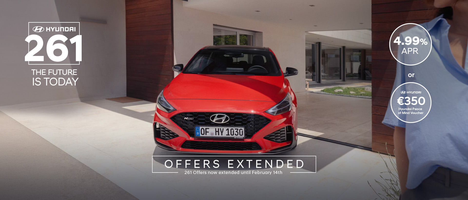 The new Hyundai i30 N Line in red parked in front of the house.